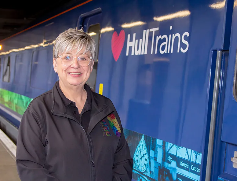 Jen standing in front of a Hull Trains unit